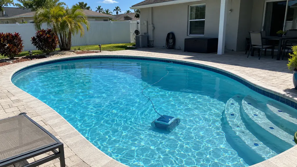 A clean pool with a robotic cleaner running