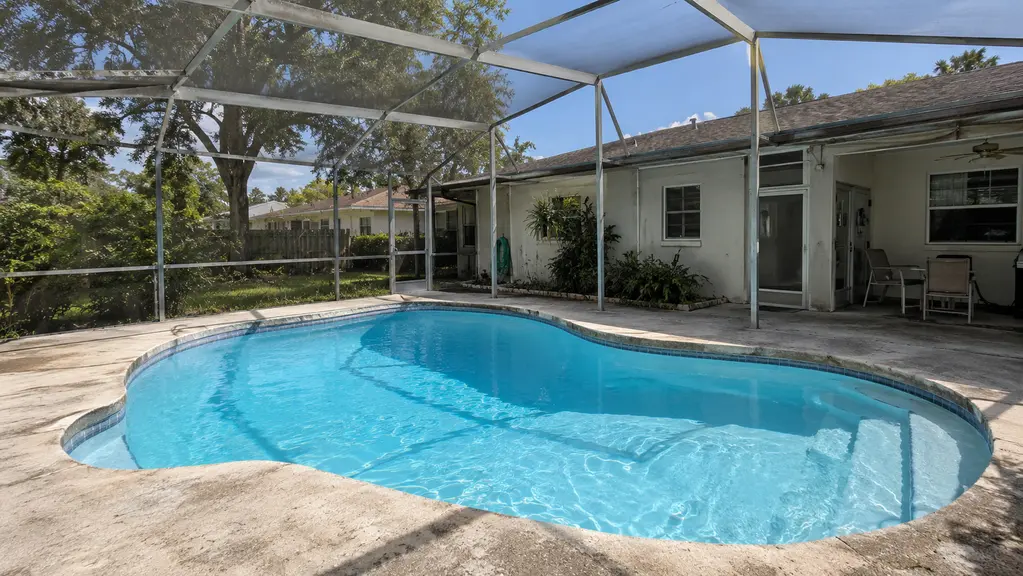 A clean pool inside a screened enclosure
