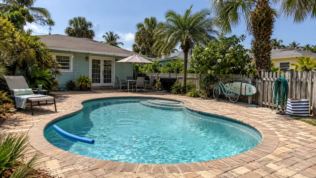 A backyard swimming pool at a home in Deerfield Beach, FL