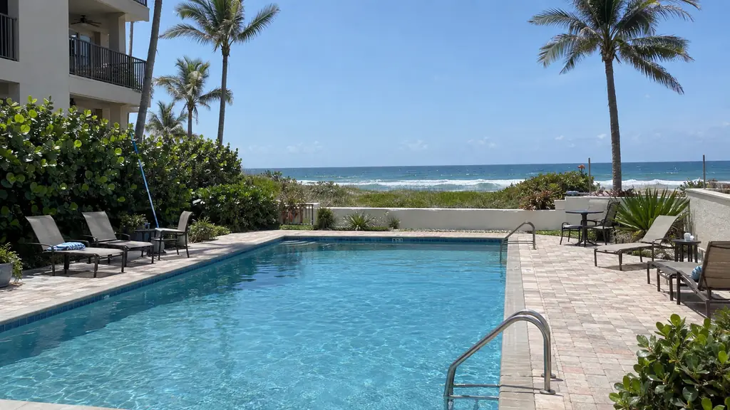 A backyard swimming pool at a home in Highland Beach, FL