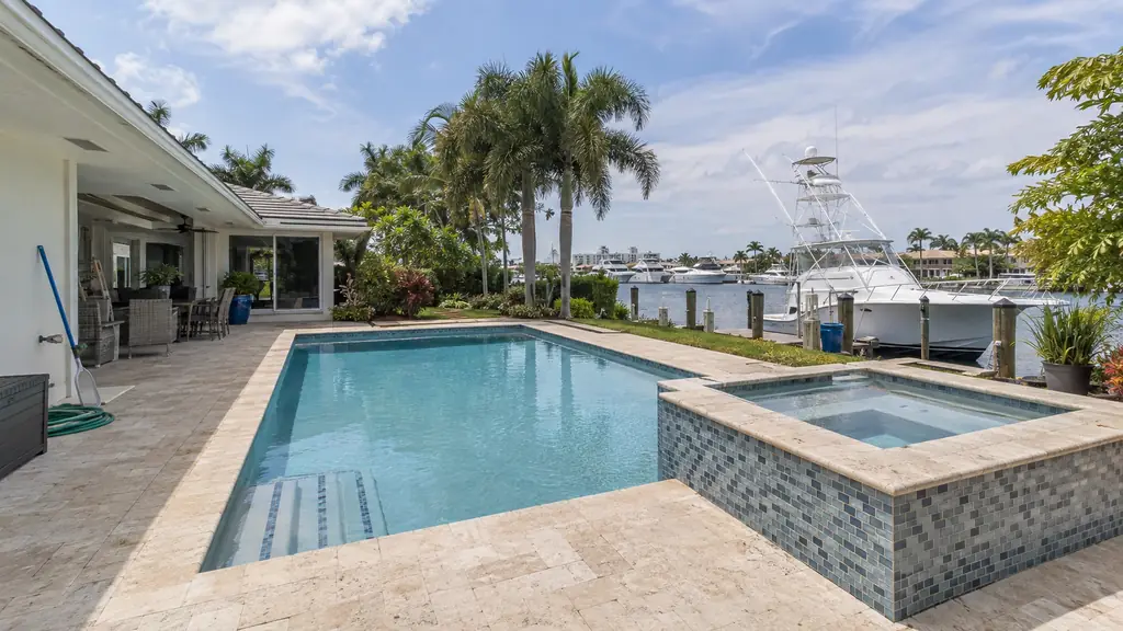 A backyard swimming pool at a home in Lighthouse Point, FL