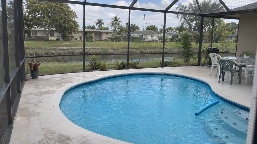 A backyard swimming pool at a home in Margate, FL