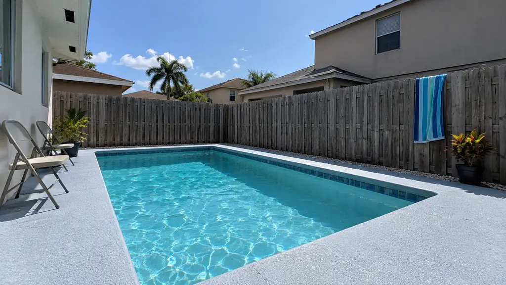 A backyard swimming pool at a home in North Lauderdale, FL
