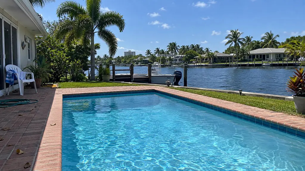 A backyard swimming pool at a home in Oakland Park, FL