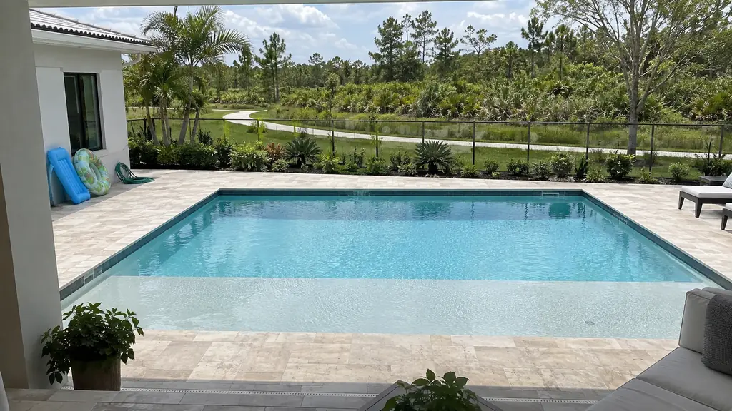 A backyard swimming pool at a home in Parkland, FL
