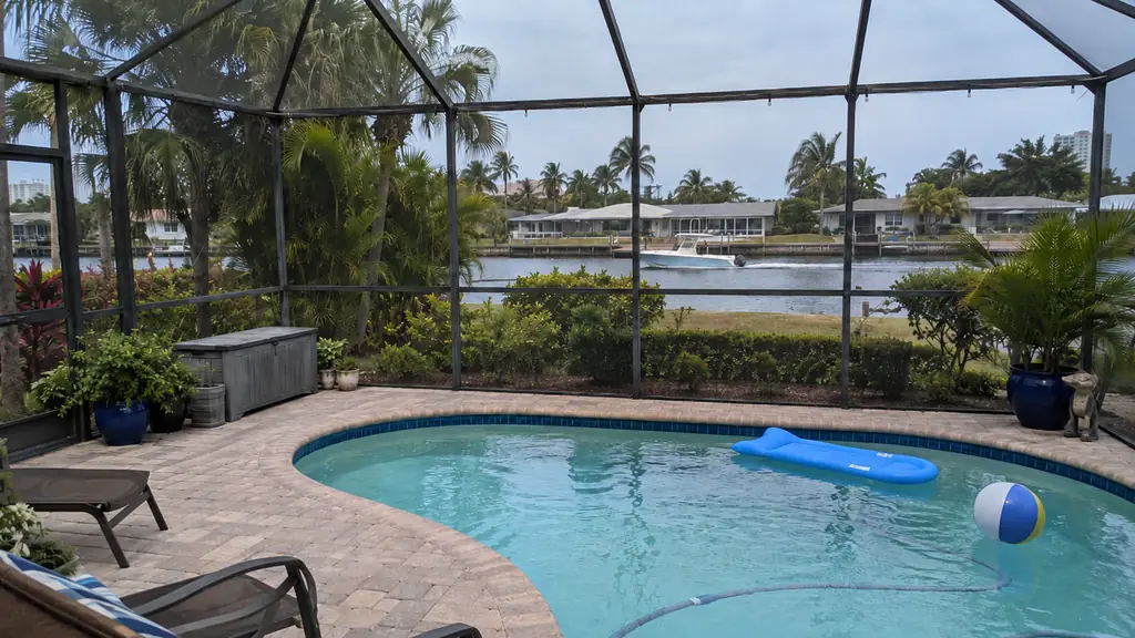 A backyard swimming pool at a home in Pompano Beach, FL