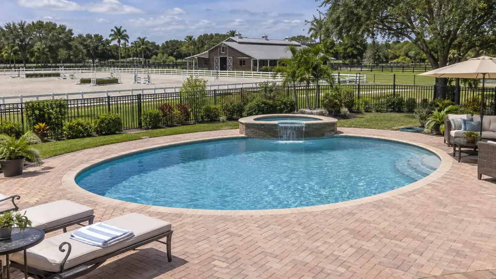 A backyard swimming pool at a home in Southwest Ranches, FL