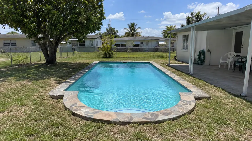 A backyard swimming pool at a home in West Park, FL